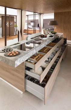 a kitchen with lots of drawers and counter tops in it's center island that is built into the wall