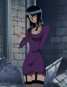 a woman with blue hair and black stockings standing in front of a brick wall holding her hands on her chest