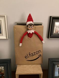 an elf sitting on top of a cardboard bag