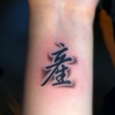 a tattoo with chinese characters on the wrist