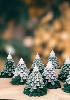 small christmas trees sitting on top of a table