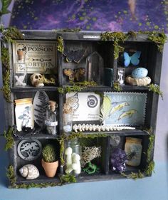 a shelf filled with lots of different types of items on top of each other in front of a purple wall