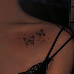 the back of a woman's shoulder with three butterflies on it