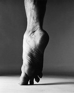 a black and white photo of a person's foot with no shoes on it