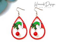 the earrings are decorated with red beads and green palm trees on it's tears