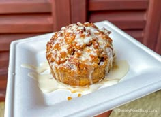 a muffin with icing on a white plate