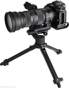 a camera on a tripod with a lens attached to the top and bottom section