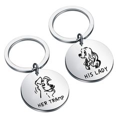 two metal key chains with the words her tramp and his lady on them