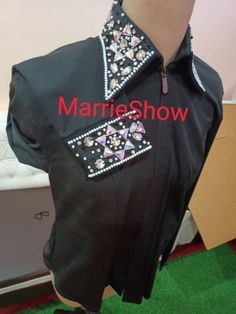 a mannequin wearing a black shirt with pink and white flowers on it