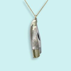 A slender, curved abalone handled knife with a semi sharp blade on a gold curb chain. Metal: Stainless steel knife, 14kt gold-filled chain Size: 1.25"L knife Lobster Clasp Material: Abalone Available in 16", 18", and 20" chain (18" Fits Most) Natural materials will vary Chain is made in the USA, Knife is made in China Word to the wise: This is a real knife and the blade is sharp. Don't wear it with the knife open. Keep it out of reach of children. Use caution when opening and closing it (if you've never opened a pocket knife, please take a minute to find a YouTube video to learn). Gold Compass Necklace, Knife Necklace, Gold Curb Chain, Abalone Necklace, Moon Necklace Silver, State Necklace, 40th Gifts, Compass Necklace, Silver Chain Bracelet