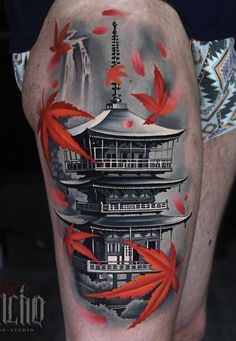 a man's thigh with red fish and pagoda tattoo on it