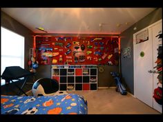 a bedroom with a bed, book shelf and toys on the wall in it's corner