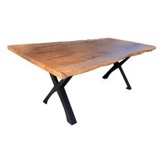 a wooden table with black metal legs and a wood slab on the top that is shaped like a cross