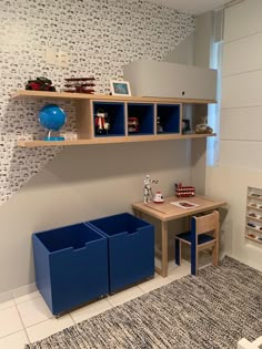 a child's playroom with blue bins and shelves