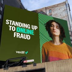 a large billboard on the side of a building with a woman's face and words standing up to online fraud