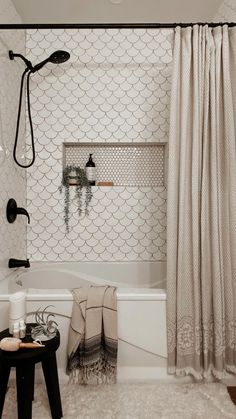 a bathroom with a bathtub and shower curtain