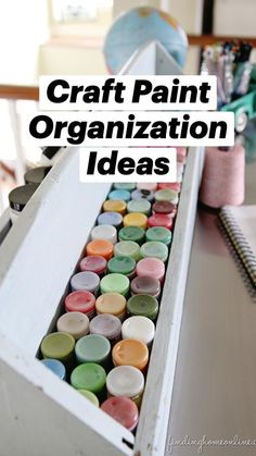 an open box filled with lots of different colored buttons and thread on top of a table