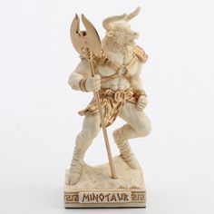 a figurine of a man with a horned head holding a spear and shield