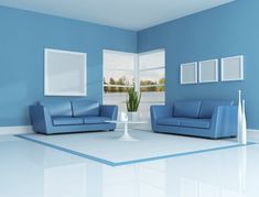 a living room with blue walls and white floors is pictured in this image, there are two couches facing each other