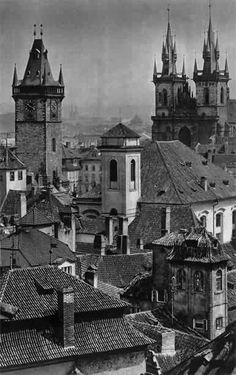 an old black and white photo of buildings in the city with spires on top