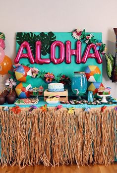 an aloha themed birthday party with balloons and decorations