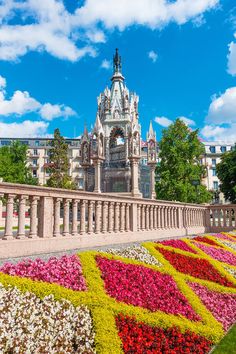 colorful flower beds in front of a large building