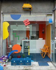 a store front with colorful furniture in the window