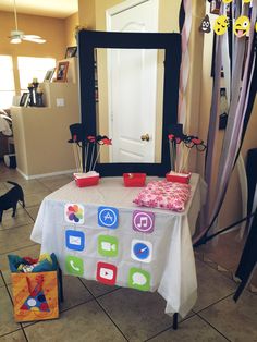 the table is set up for an event with decorations on it and a mirror in the background