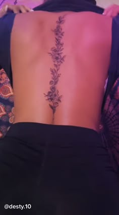 the back of a woman's lower back tattoo