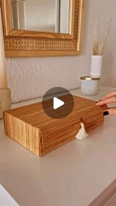 a person cutting up food on top of a wooden counter in front of a mirror