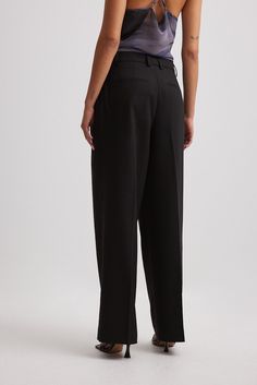 These trousers feature a tailored fit. They have a high waist fit and a long wide leg. These trousers feature a pleated design, an adjustable detail on the waist and on the inside, side slant pockets and back mock pockets. Wide Leg Suit Pants, Future Fashion, Suit Pants, Pants Black, Black Noir, Industrial Style, Women Empowerment, Black Pants, High Waist