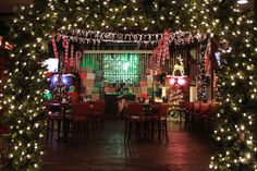 a restaurant decorated for christmas with lights and decorations