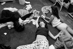 three people laying on the ground playing with wii motes and video game remotes