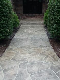 a stone walkway in front of a brick building