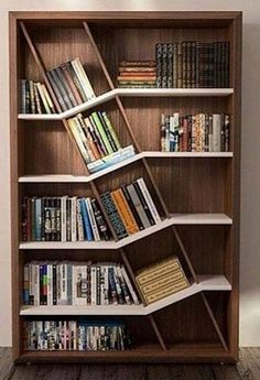 a bookshelf filled with lots of books on top of wooden shelves next to a wall