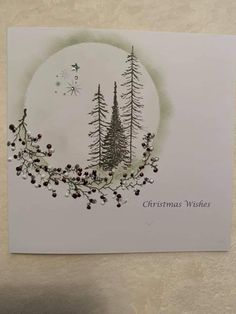 a christmas card with pine trees and berries