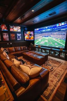 a living room with couches and large televisions