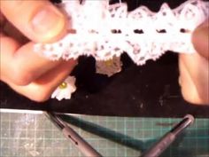 someone is crocheting the edge of a piece of lace