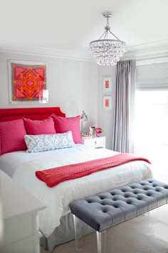 a bedroom with pink and gray walls and furniture