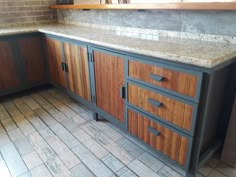 a kitchen with wooden cabinets and tile flooring