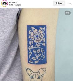 a tattoo on the arm of a person with a dog and flower in front of it