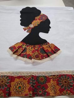 an image of a woman's head on top of a white table cloth with red and gold trim