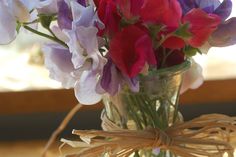 a vase filled with purple and red flowers