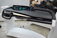 an electronic device is sitting on top of a desk in the shape of a car