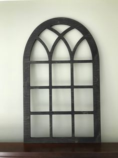 an arched window on top of a dresser