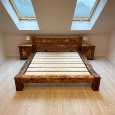 a bed sitting in the middle of a room with two windows on top of it