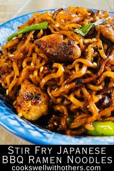 stir fry noodles with chicken and vegetables in a blue bowl on a wooden table, text reads stir fry japanese bbq ramen noodles