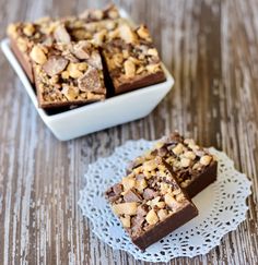 two pieces of chocolate brownie on a doily