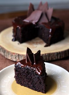 two pieces of chocolate cake sitting on top of a white plate next to each other