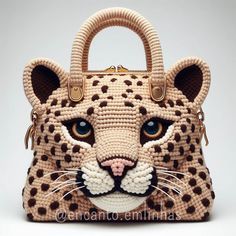 a crocheted handbag with a leopard's face on the front and sides